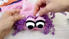 a person is making a stuffed animal with yarn and buttons on it's eyes