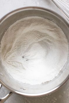 a metal pot filled with flour on top of a counter