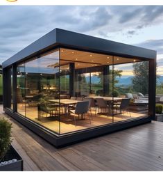 a glass walled dining room on a deck