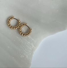 An easy piece that will go with anything and everything. You can also wear it stacked in your first and second piercing. 14K gold filled  Tarnish resistant and water friendly Gold filled is constructed with two layers. The core metal is jeweler's brass and the second metal is either 14k or 18k gold. The thick layer of gold is pressure bonded to the brass using heat. The final product is a quality piece of jewelry, that is water friendly and tarnish resistant. It looks like gold without paying th Twisted Earrings, Second Piercing, Gold Filled Jewelry, Jewelry Earrings Hoops, Solid Gold, Gold Filled, Piercings, 18k Gold, Two By Two