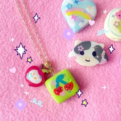 the necklaces are decorated with different designs and colors on pink fabric, along with other items