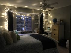 a bed room with a neatly made bed and lots of lights