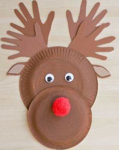 a brown paper plate with a reindeer head on it's face and red nose