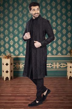 Introducing our exquisite Mens Sherwani- V2-S043, a sophisticated addition to your wardrobe. This luxurious black sherwani features intricate cutdana and zardozi embroidery, elevating its elegant design. It also includes a matching dupatta. This sherwani exudes exclusivity and refinement. Indulge in a timeless piece of art, with our Mens Sherwani-V2-S043. Black Sherwani For Winter Wedding, Black Wedding Sherwani For Winter, Black Winter Wedding Sherwani, Designer Black Nehru Jacket With Traditional Drape, Formal Black Sherwani With Dabka Work, Elegant Black Kurta With Naqshi Detailing, Designer Black Sherwani With Resham Embroidery, Formal Black Sherwani With Dupatta, Elegant Black Kurta With Naqshi