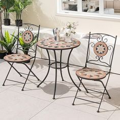 an outdoor table and chairs set up on the patio