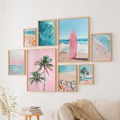 a living room filled with furniture and pictures hanging on the wall above a white couch