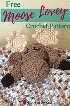 a crocheted moose laying on top of a blanket with text overlay that reads free moose lovey crochet pattern