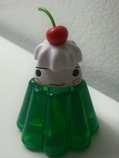 a plastic toy with a cherry on top of it