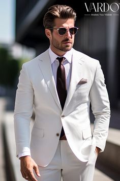 a man in a white suit and sunglasses