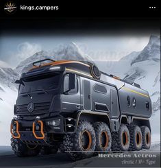 an image of a large truck in the middle of snow covered mountains with orange rims