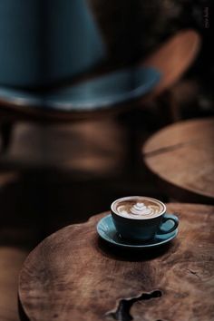 a cappuccino sitting on top of a wooden table