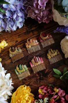 flowers and hair combs laid out on a wooden table with purple, yellow, and white flowers