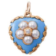 Wonderful representative of antique Victorian era Mourning jewelry, this delicate 14k gold heart pendant is set with bright turquoise blue enamel, pearls and an old mine cut diamond in the center, weighing approx. 0.05ct, The pendant has a hair locket in the back, typical for the time when it was crafted. The piece measures 7/8" x 6/8". Weighs 5.9 grams. Hair Locket, Heart Pendant Gold, Bleu Turquoise, Natural Pearl, Diamond Gold, Gold Hair, Pearl Diamond, Heart Locket, Body Jewellery