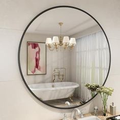 a white bath tub sitting under a round mirror