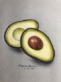 an avocado drawing with colored pencils is shown on a gray surface, and it has two halves cut in half