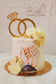 a wedding cake decorated with two hands and flowers