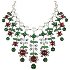 This very early Chanel Gripoix and Pearl Bib Necklace is in excellent vintage condition. It is a one of a kind highly collectible piece designed by Coco herself from the Diana Vreeland estate sale. Faux pearl choker with red and green dripping Gripoix stones and crystals. Extremely rare. Measures approximatley 17inches. Vintage Chanel Jewelry, Pearl Bib Necklace, Buy Earrings Online, Rhinestone Costume Jewelry, Necklaces Choker, Vintage Choker Necklace, Unique Fashion Jewelry, Diana Vreeland, Vintage Choker