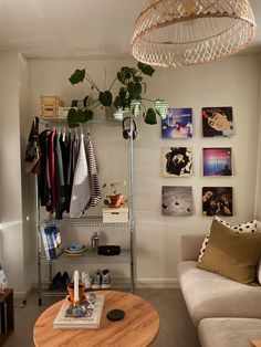 a living room filled with furniture and lots of pictures on the wall next to a coffee table