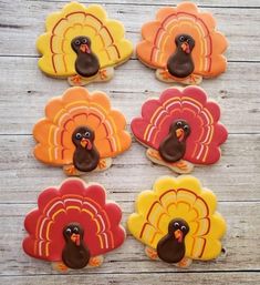 turkey cookies decorated with royal icing on a wooden table