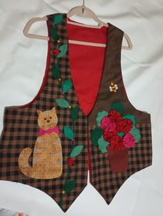 two vests with cats and flowers on them