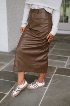 Expertly crafted with a high waistline, this brown faux leather midi skirt is both stylish and functional. Complete with pockets for added convenience, this skirt is the perfect addition to any wardrobe. Add a touch of sophistication to your outfit with this must-have piece! 100% polyurethane Model is 5'4" with a 25" waist and 38" hips and wearing a small. Size recs: 2-4 S 4-6 M 8-10 L High Waist Brown Skirt With Pockets, Casual Brown High Waist Pencil Skirt, Chic High Waist Brown Skirt, Chic Brown Skirt With Pockets, Brown Lined Skirt For Fall, Brown Midi Skirt For Fall, Brown Midi Pencil Skirt For Fall, Fall Midi Skirt With Side Pockets, Brown Pencil Skirt With Pockets