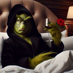 a person in a costume is holding a glass of wine while sitting on a bed