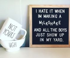 two coffee mugs sitting on top of a table next to a sign that says i hate it when im making a milkshake and all the boys just show up in my yard