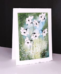 a card with white flowers painted on it