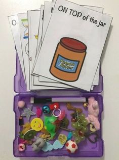 a purple container filled with lots of toys and magnets on top of a table