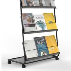 a three tiered book rack with magazines on it's sides and black wheels