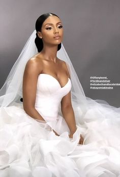 a woman in a wedding dress sitting down