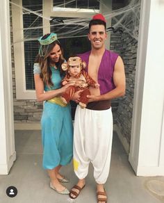 the man and woman are dressed up as disney characters