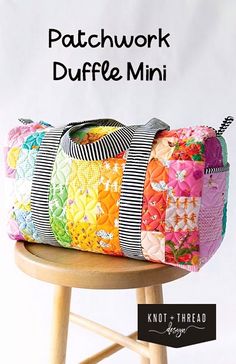 a colorful patchwork duffle bag sitting on top of a wooden stool