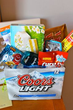 a bag filled with candy and snacks sitting on top of a wooden table next to a wall