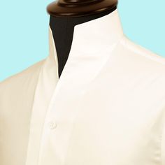 High Open Collar Full Sleeves Shirt Tailor-Made On Order shirt 𝘈 𝘩𝘪𝘨𝘩 𝘤𝘰𝘭𝘭𝘢𝘳 𝘴𝘩𝘪𝘳𝘵 𝘪𝘴 𝘢 𝘤𝘭𝘢𝘴𝘴𝘪𝘤 𝘢𝘯𝘥 𝘵𝘪𝘮𝘦𝘭𝘦𝘴𝘴 𝘴𝘵𝘺𝘭𝘦 𝘵𝘩𝘢𝘵 𝘢𝘥𝘥𝘴 𝘢 𝘵𝘰𝘶𝘤𝘩 𝘰𝘧 𝘴𝘰𝘱𝘩𝘪𝘴𝘵𝘪𝘤𝘢𝘵𝘪𝘰𝘯 𝘵𝘰 𝘢𝘯𝘺 𝘰𝘶𝘵𝘧𝘪𝘵. 𝘛𝘩𝘪𝘴 𝘴𝘵𝘺𝘭𝘦 𝘧𝘦𝘢𝘵𝘶𝘳𝘦𝘴 𝘢 𝘤𝘰𝘭𝘭𝘢𝘳 𝘵𝘩𝘢𝘵 𝘴𝘵𝘢𝘯𝘥𝘴 𝘶𝘱 𝘢𝘯𝘥 𝘦𝘯𝘤𝘪𝘳𝘤𝘭𝘦𝘴 𝘵𝘩𝘦 𝘯𝘦𝘤𝘬, 𝘱𝘳𝘰𝘷𝘪𝘥𝘪𝘯𝘨 𝘢 𝘳𝘦𝘧𝘪𝘯𝘦𝘥 𝘢𝘯𝘥 𝘱𝘰𝘭𝘪𝘴𝘩𝘦𝘥 𝘭𝘰𝘰𝘬. 𝘐𝘵'𝘴 𝘢 𝘷𝘦𝘳𝘴𝘢𝘵𝘪𝘭𝘦 𝘱𝘪𝘦𝘤𝘦 𝘰𝘧 𝘤𝘭𝘰𝘵𝘩? Semi-formal Top With Fold Down Collar And Placket, Semi-formal Top With Placket And Fold-down Collar, White Stand Collar Shirt With Button Closure, White Formal Tops With Placket, Classic White Shirt With Stand Collar, Formal White Tops With Placket, White Formal Tops With Covered Buttons, Formal White Tops With Covered Buttons, White Formal Shirt With Stand Collar