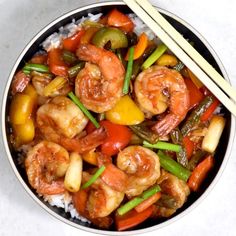 shrimp and vegetable stir fry in a bowl with chopsticks