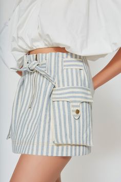 Equally chic and versatile, our denim skirt is woven from upcycled cotton into a vintage blue and white stripe without the use of toxic chemicals. Designed to sit high on your waist with a paperbag look, this style fastens with a center-front zip and a built-in belt to cinch the waist as desired. This mini skirt has an A-line cut with functional cargo pockets. Pair with sandals, white sneakers and booties for picnic-perfect days, beach walks or road trips. It’s an everyday staple. This item is m Perfect Days, Beach Walks, Vintage Blue And White, Toxic Chemicals, Sandals White, Beach Walk, Stripe Skirt, Casablanca, White Sneakers