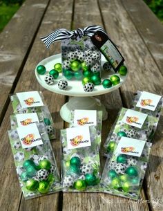 there are many green and white balls on the table with tags in front of them