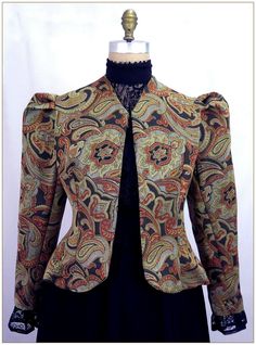 Poly Jacquard. Color: Multi. Beautiful multi color jacquard woven design. Small paisley pattern in gold, black and copper colors. Fitting darts front and back and shoulder pleated Victorian two piece sleeves. Unlined jacket perfect for outdoor wear in all weather. Dry clean. Circa 1890-1905. Made in U.S.A. Sizes: SM, MED LG & XLG. Jackets ordered by bust measurement, inches: BUST         SIZES 32" - 34"   SMALL 35" - 39"   MEDIUM 40" - 44"   LARGE 45" - 49"   XLARGE Jackets ordered by bust measu Edwardian Jacket, Ruffle Long Sleeve Blouse, Victorian Blouse, Formal Shirt Dress, Floral Lace Blouse, Jacquard Jacket, Velvet Blouses, Edwardian Fashion, Vintage Coat