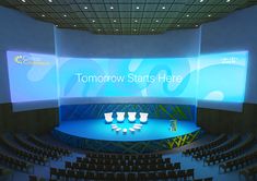 an empty auditorium with rows of seats and large screens on the wall above it that says tomorrow starts here