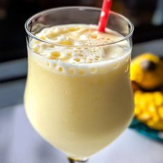 a close up of a drink in a glass with a straw sticking out of it