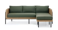 a green couch and ottoman sitting next to each other