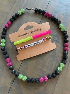 Elevate your party-ready look with our vibrant Party Animals bracelet set! Handmade with love, these dynamic accessories feature a vibrant combination of hot pink, lime green, and sleek black beads. Don't fade into the background - stand out in style and unleash your inner Party Animal at every ball game! And that's not all! This listing also includes a dazzling Party Animals bling necklace, adorned with pink, green, and black round rhinestone beads, ensuring you stand out from the crowd. 🙊⚾️🎉 Casual Letter Beads Jewelry For Party, Casual Party Jewelry With Letter Beads, Casual Green Jewelry For Party, Fun Black Jewelry For Birthday, Black Party Bracelet With Letter Beads, Playful Black Adjustable Jewelry, Black Letter Beads Bracelet For Party, Playful Black Jewelry With Letter Beads, Black Letter Beads Bracelets For Parties