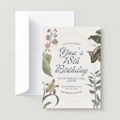 an elegant birthday card with flowers and greenery on the front is shown in white