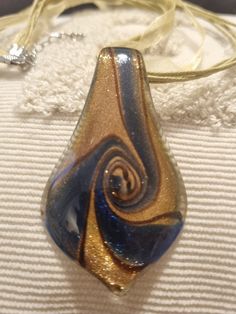 Amazing Blue and Gold  Sparkling swirl Glass pendant necklace On a Gold/Green boohoo necklace  A fabulous statement piece Great for every Occasion  This is handmade and has some imperfections Glass Pendant Necklace, Blue And Gold, Gold Gold, Glass Pendant, Glass Pendants, Blue Gold, Pendant Necklaces, Swirl, Jewelry Necklace Pendant