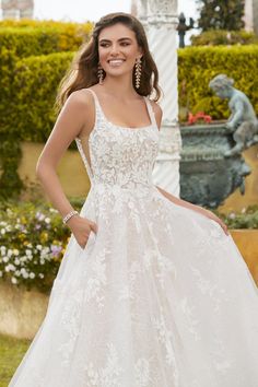 a woman in a wedding dress posing for the camera