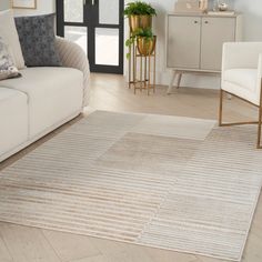 a living room with a white couch and beige rug