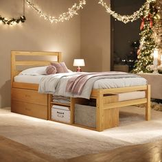 a bedroom with a bed, dresser and christmas lights