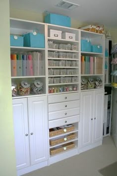 a white bookcase with lots of crafting supplies