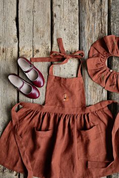 a pair of shoes and a dress on a wooden surface